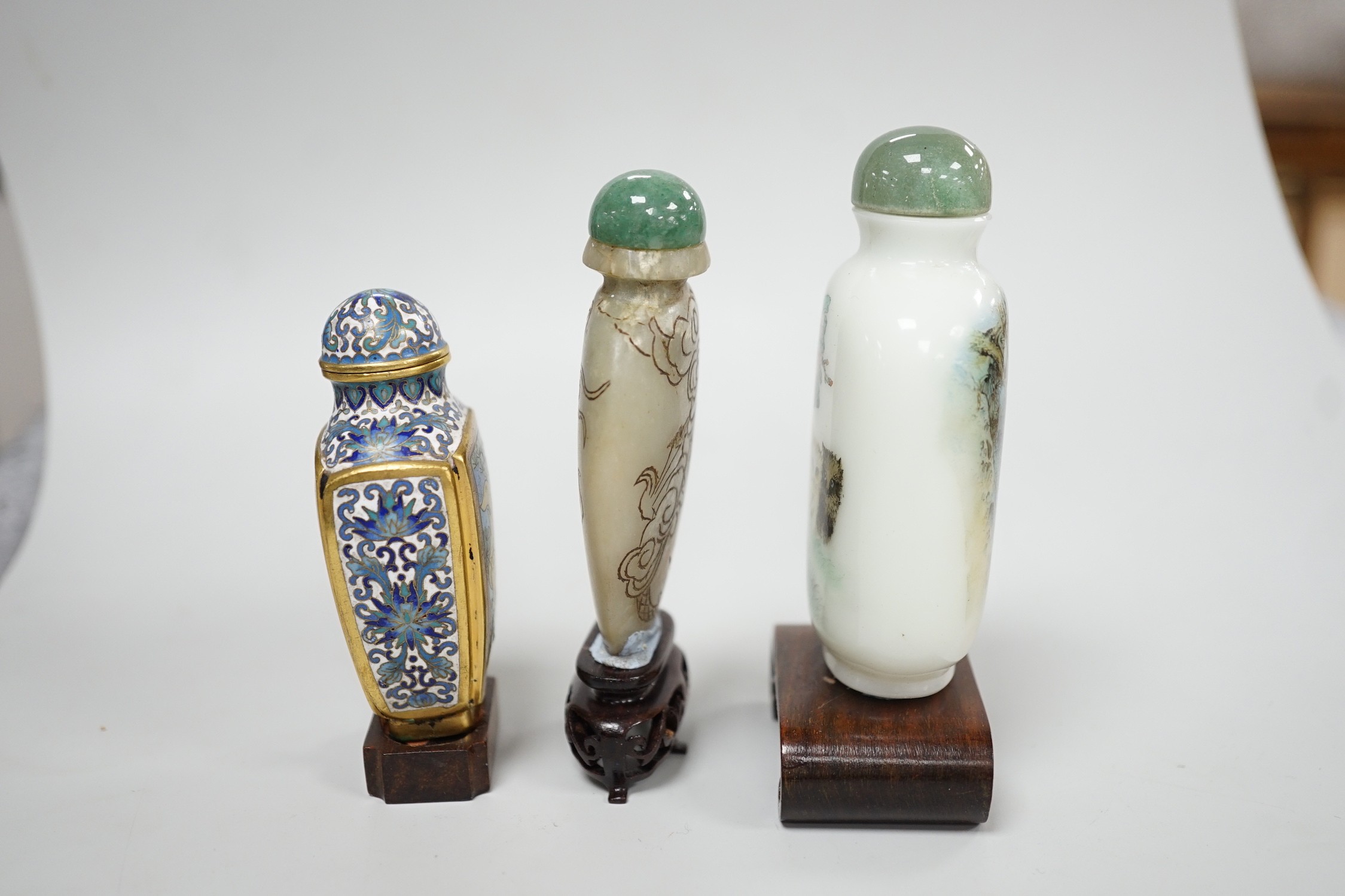 A Chinese cloisonné enamel snuff bottle, enamelled glass and stone snuff bottles. Tallest 8cm (3)